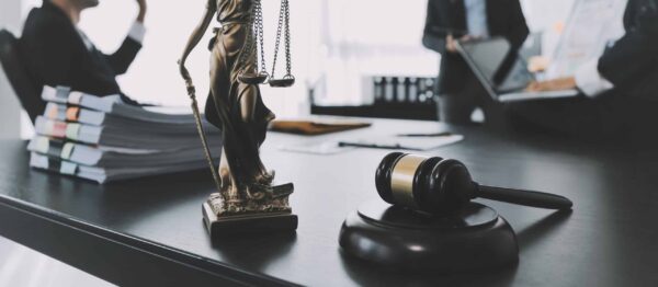 consultation and conference of male lawyers and professional businesswoman working and discussion having at law firm in office. concepts of law, judge gavel with scales of justice.